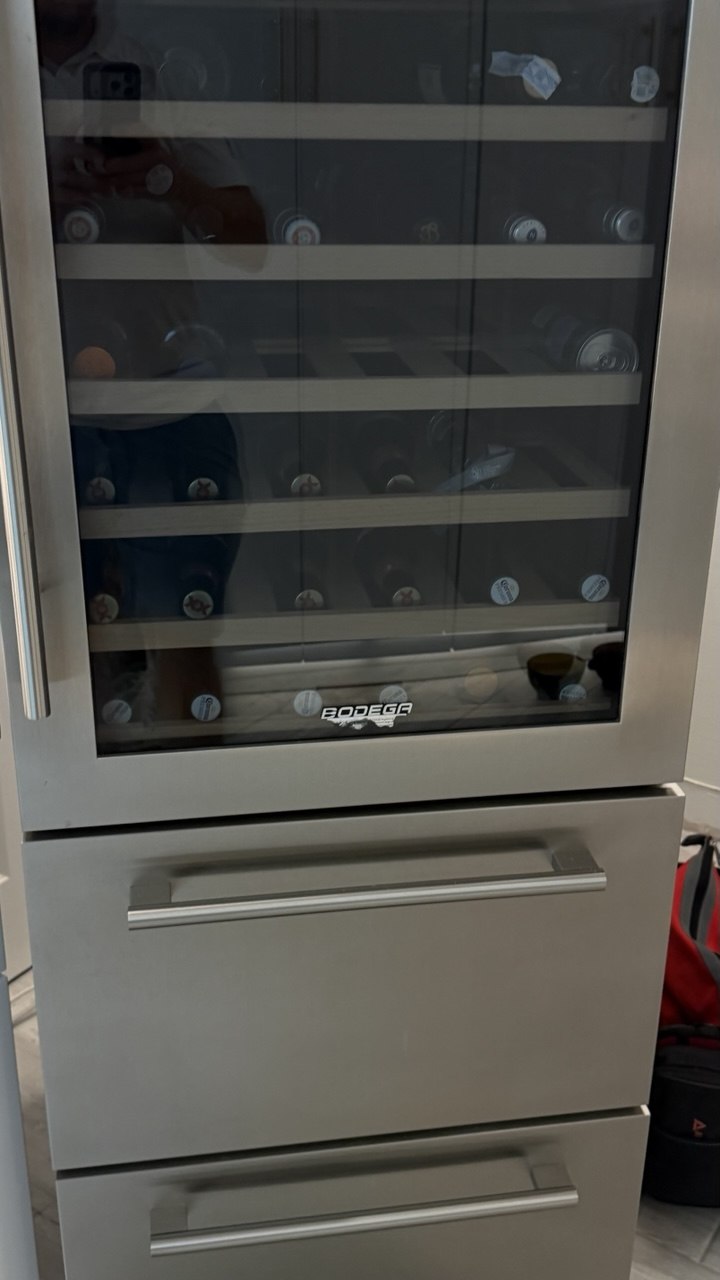 Refrigerator repair in progress in a Naples home