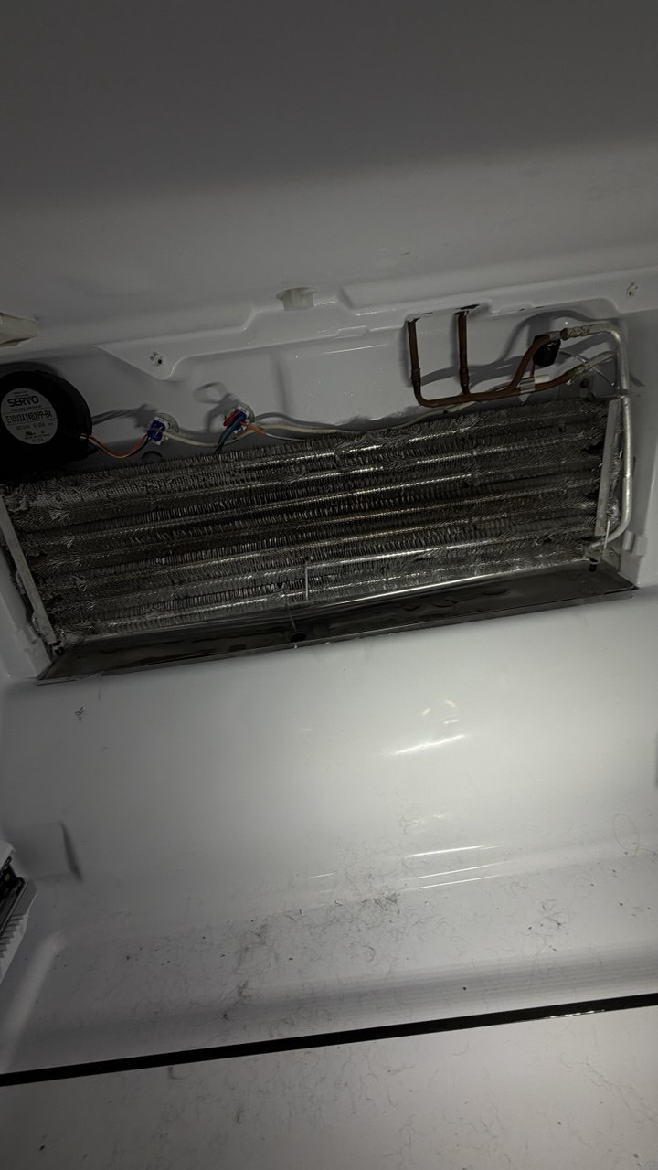 Refrigerator repair in progress in a Naples home