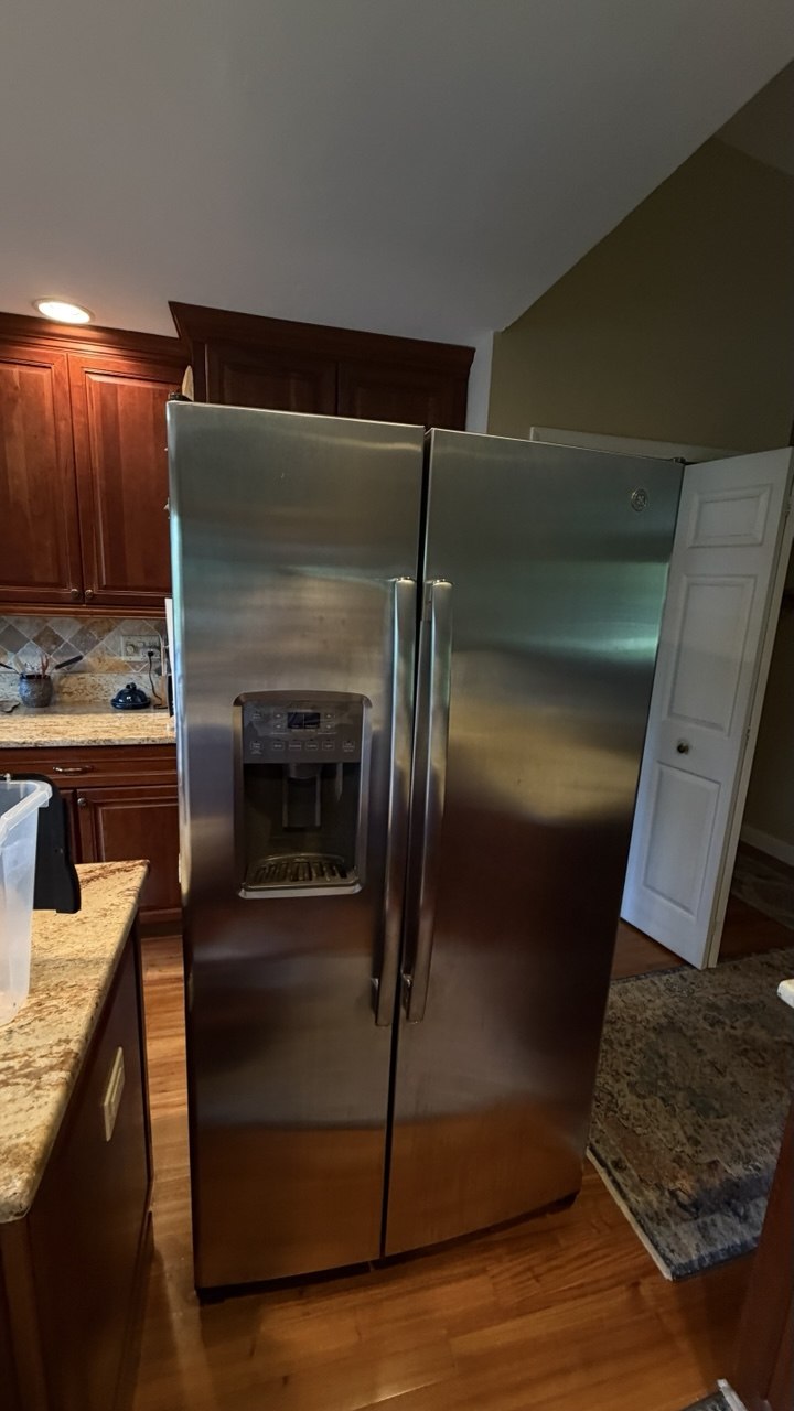 Refrigerator repair in progress in a Naples home