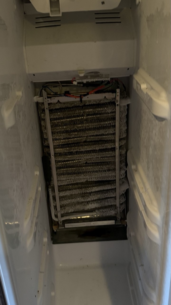 Refrigerator repair in progress in a Naples home
